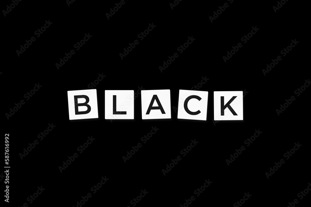 The word BLACK, spelt with letter Scrabble tiles on a black background The word BLACK, spelt with letter Scrabble tiles on a black background