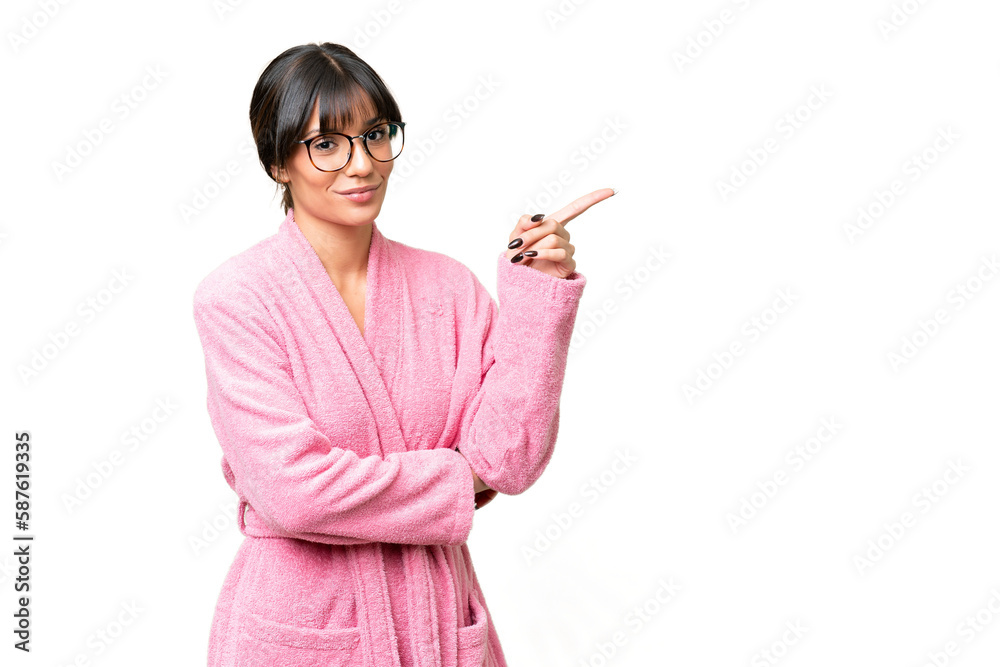 Young woman in bathrobe over isolated chroma key background pointing finger to the side Young woman in bathrobe over isolated chroma key background pointing finger to the side