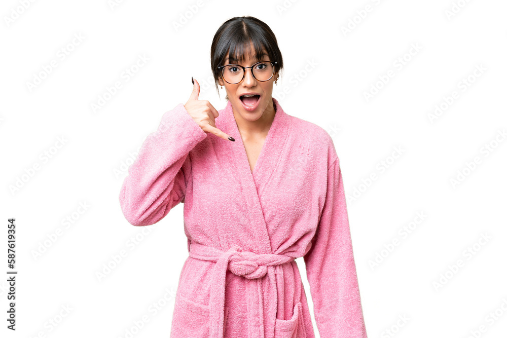 Young woman in bathrobe over isolated chroma key background making phone gesture. Call me back sign