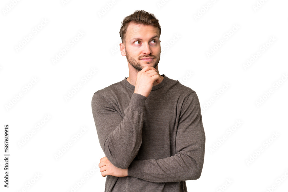 Young handsome caucasian man over isolated chroma key background and looking up Young handsome caucasian man over isolated chroma key background and looking up