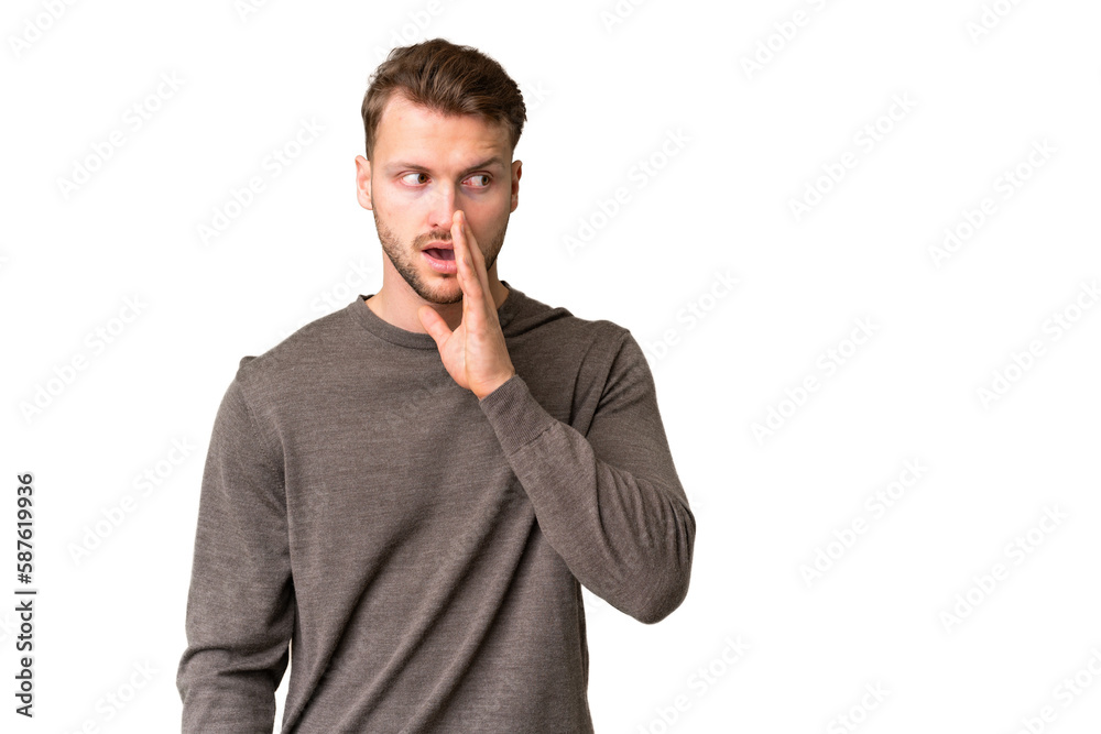 Young handsome caucasian man over isolated chroma key background whispering something with surprise gesture while looking to the side Young handsome caucasian man over isolated chroma key background whispering something with surprise gesture while looking to the side