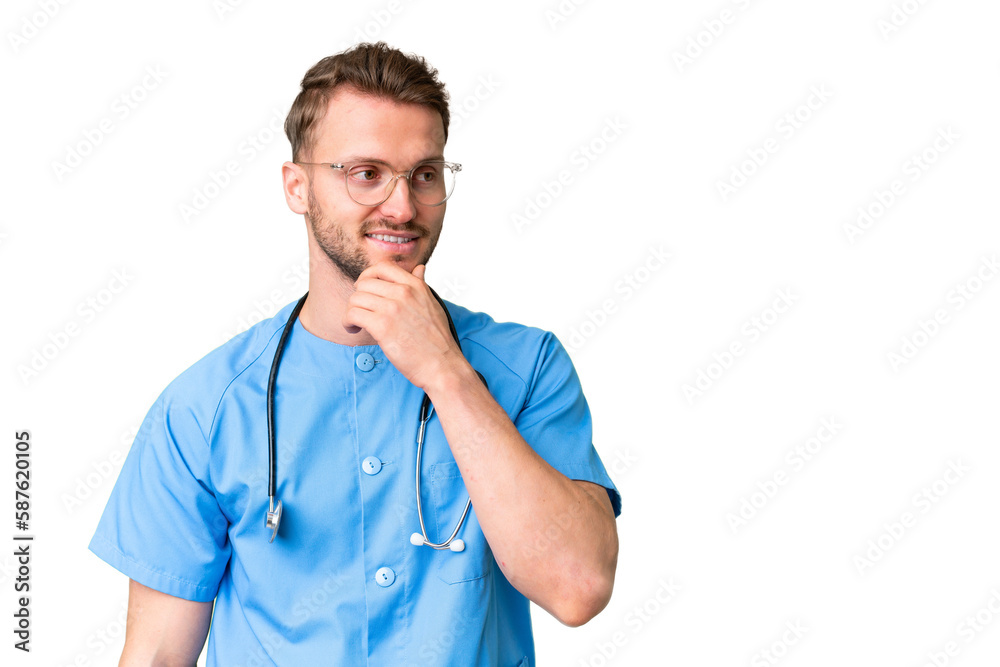 Young nurse man over isolated chroma key background looking to the side Young nurse man over isolated chroma key background looking to the side