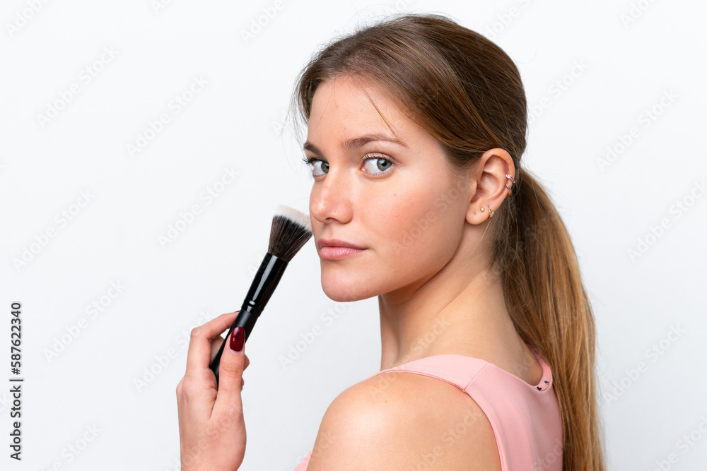 Young caucasian woman isolated on white background holding makeup brush Young caucasian woman isolated on white background holding makeup brush