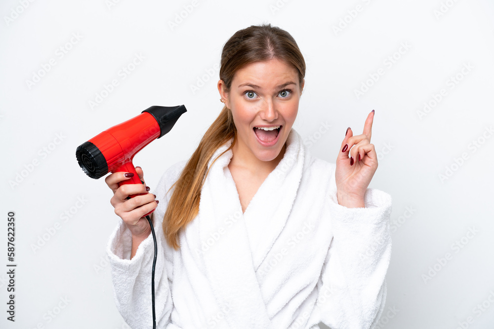 Young caucasian woman holding hairdryer isolated on white background pointing up a great idea Young caucasian woman holding hairdryer isolated on white background pointing up a great idea