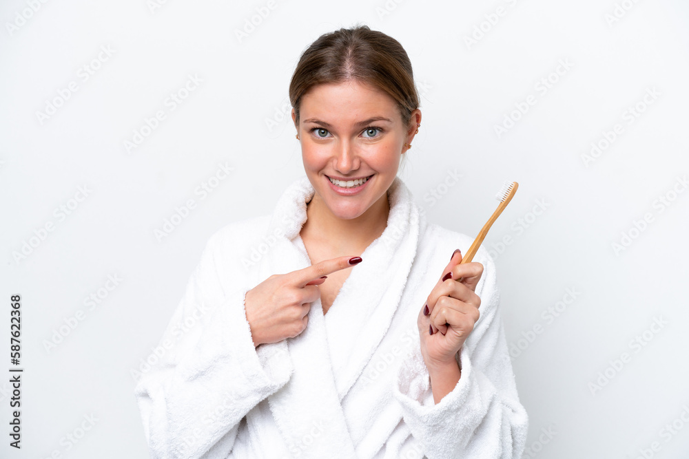 Young caucasian woman brushing teeth isolated on white background with surprise facial expression Young caucasian woman brushing teeth isolated on white background with surprise facial expression