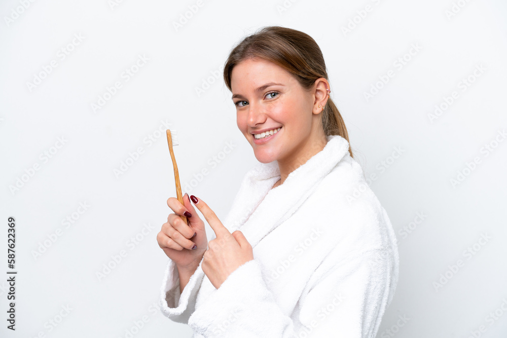 Young caucasian woman brushing teeth isolated on white background and pointing it Young caucasian woman brushing teeth isolated on white background and pointing it