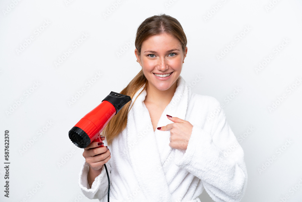 Young caucasian woman holding hairdryer isolated on white background with surprise facial expression Young caucasian woman holding hairdryer isolated on white background with surprise facial expression