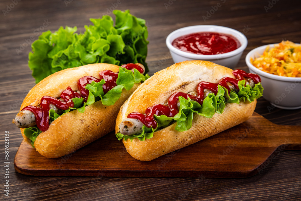 Hot dogs, coleslaw and ketchup on wooden table
