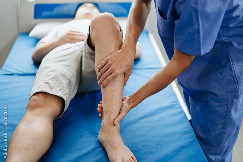 Obraz premium Close up of Physiotherapist working with patient on the bed.