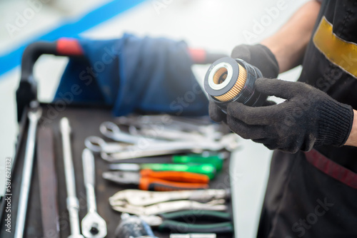 Mechanic changing car oil filter in auto service center
