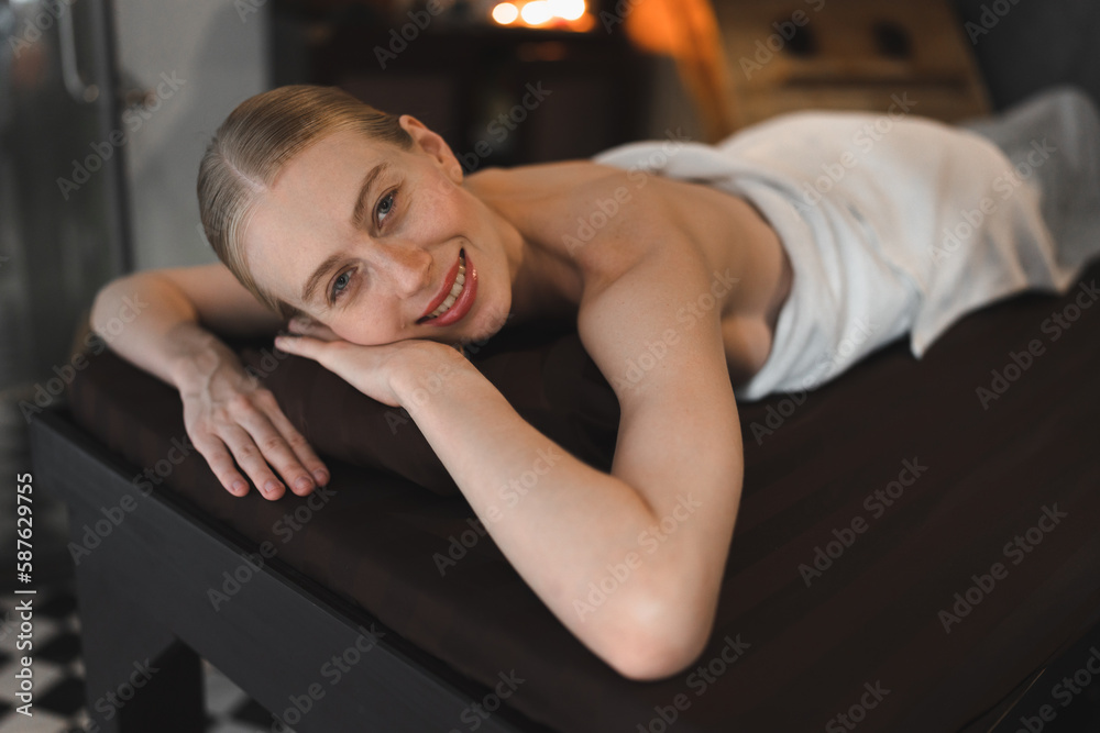 Fototapeta premium Relaxed Caucasian woman by therapist in spa salon 