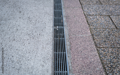 Wallpaper Mural Stainless steel grated flood water storm drain on a Tokyo sidewalk, Japan Torontodigital.ca