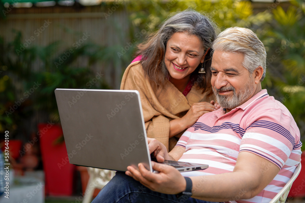 Indian senior couple using laptop. technology concept. Indian senior couple using laptop. technology concept.