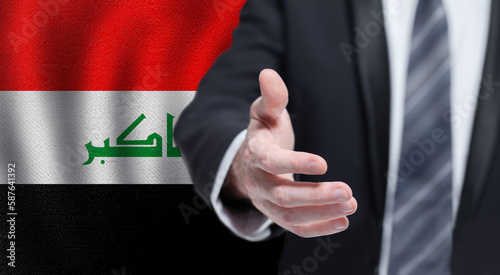 Iraqi business, politics, cooperation and travel concept. Hand on flag of Iraq background.