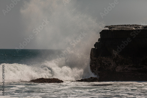 Huge waves crashing on the cliffs near Tanah Lot hindu temple, Bali, Indonesia