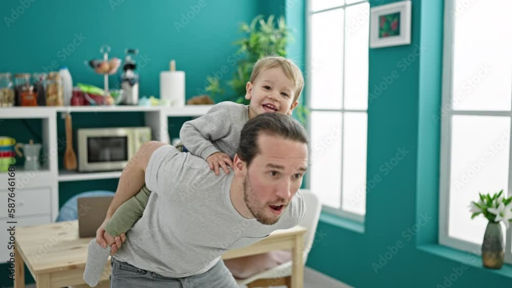 Father and son smiling confident dancing together at dinning room Father and son smiling confident dancing together at dinning room