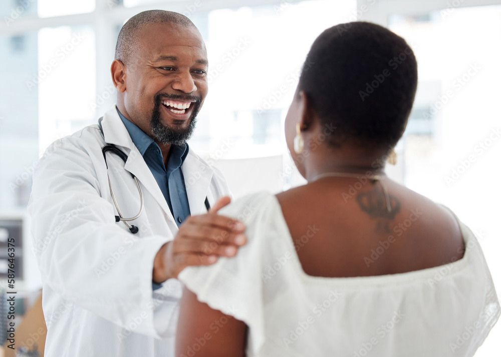 Doctor, black man and touch shoulder of patient for support, comfort and reassure in hospital. Healthcare, consultation and happy medical professional talking, good news or laughing with mature woman Doctor, black man and touch shoulder of patient for support, comfort and reassure in hospital. Healthcare, consultation and happy medical professional talking, good news or laughing with mature woman