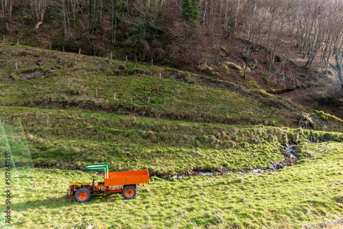 Farmers tractor in a green and humid landscape