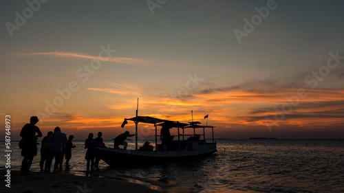 Boat trip during beautiful sunset over tropical Indonesian Island Karimunjava.  photo