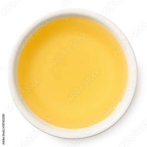 Agave syrup in a white ceramic bowl isolated on white from above.