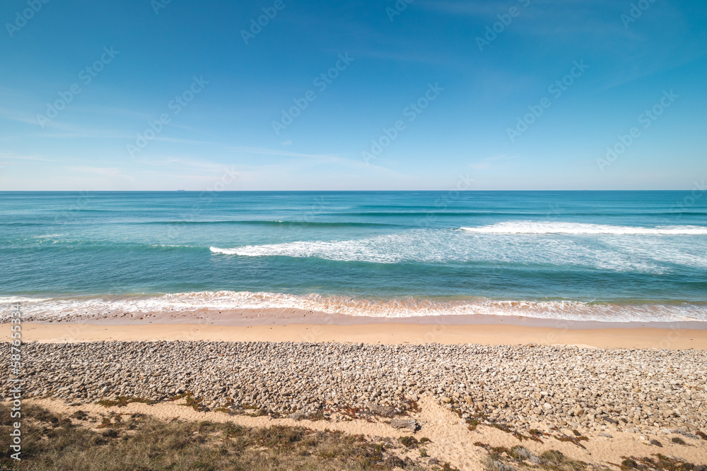 Atlantic Ocean, with its waves, has washed up on the Portuguese coast a multitude of pebbles on the sandy beach, creating a beautiful setting for a day out. Fisherman Trail Atlantic Ocean, with its waves, has washed up on the Portuguese coast a multitude of pebbles on the sandy beach, creating a beautiful setting for a day out. Fisherman Trail