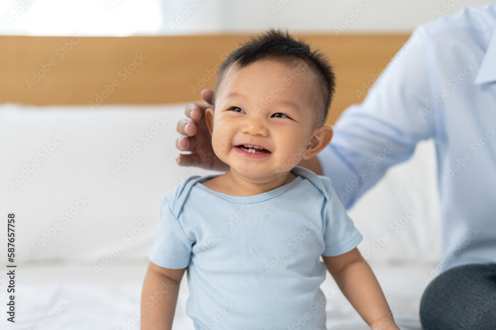 Portrait of enjoy happy love family asian father playing with adorable little asian baby.newborn, infant.dad touching with cute son moments good time in a white bedroom.father day, Love of family Portrait of enjoy happy love family asian father playing with adorable little asian baby.newborn, infant.dad touching with cute son moments good time in a white bedroom.father day, Love of family