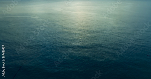 Top- view blue seawater texture, Sunshine Refection on blue water wave texture background.
