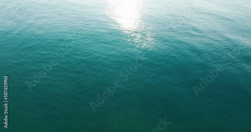 Top- view blue seawater texture, Sunshine Refection on blue water wave texture background.
