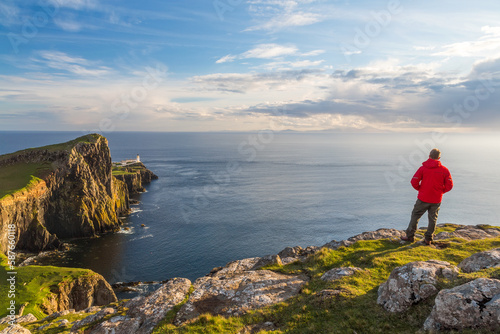 Man admiring the view,lighthouse, Neist Point, Isle of Skye, Scotland