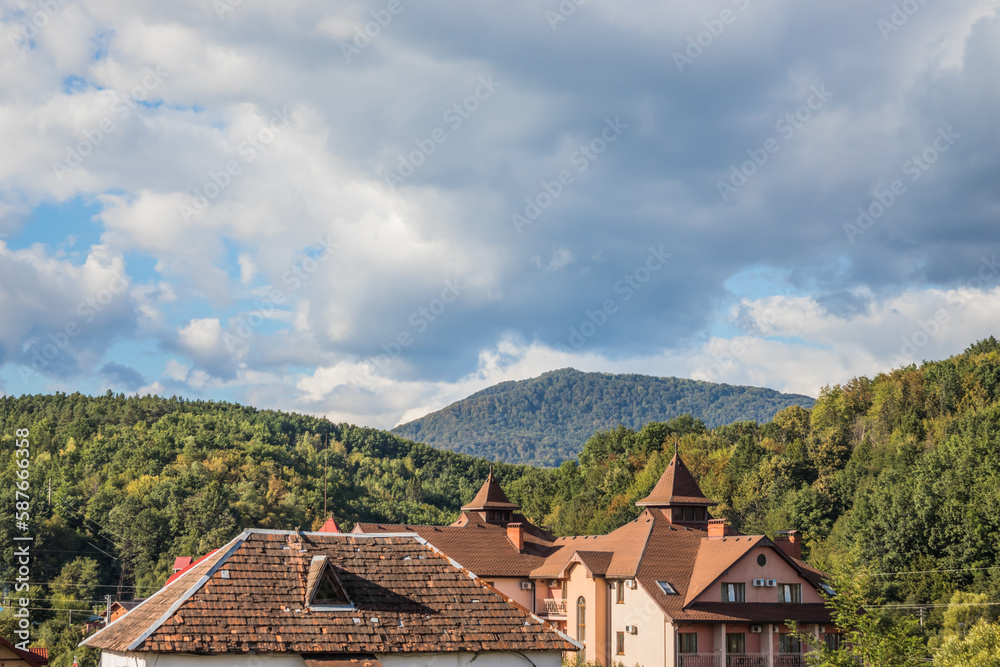 Mountain from view with small village sunny day. Sunny summer morning in the mountains and a small village. Country road in the mountains. Carpathians. Polyana. Ukraine