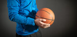 Caucasian man holding basketball ball.