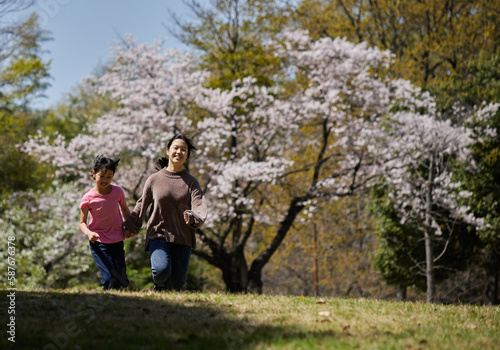 春の桜満開の公園で遊んでいる子供姉妹の様子 © zheng qiang