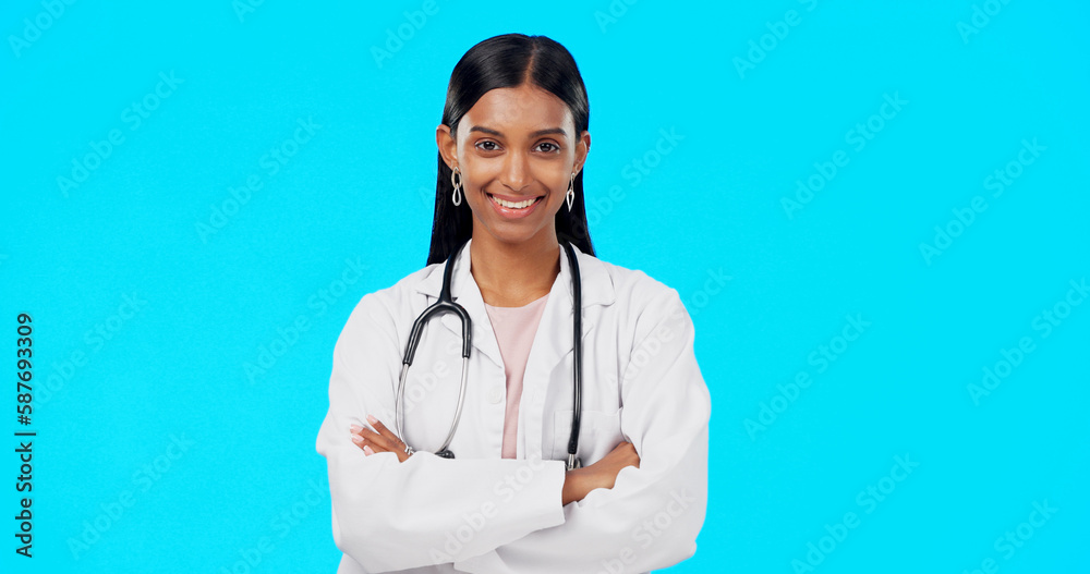 Studio woman, confidence and happy doctor, female surgeon or nurse for support, medical healthcare or health. Medicine professional pride, cardiology portrait and hospital person on blue background Studio woman, confidence and happy doctor, female surgeon or nurse for support, medical healthcare or health. Medicine professional pride, cardiology portrait and hospital person on blue background
