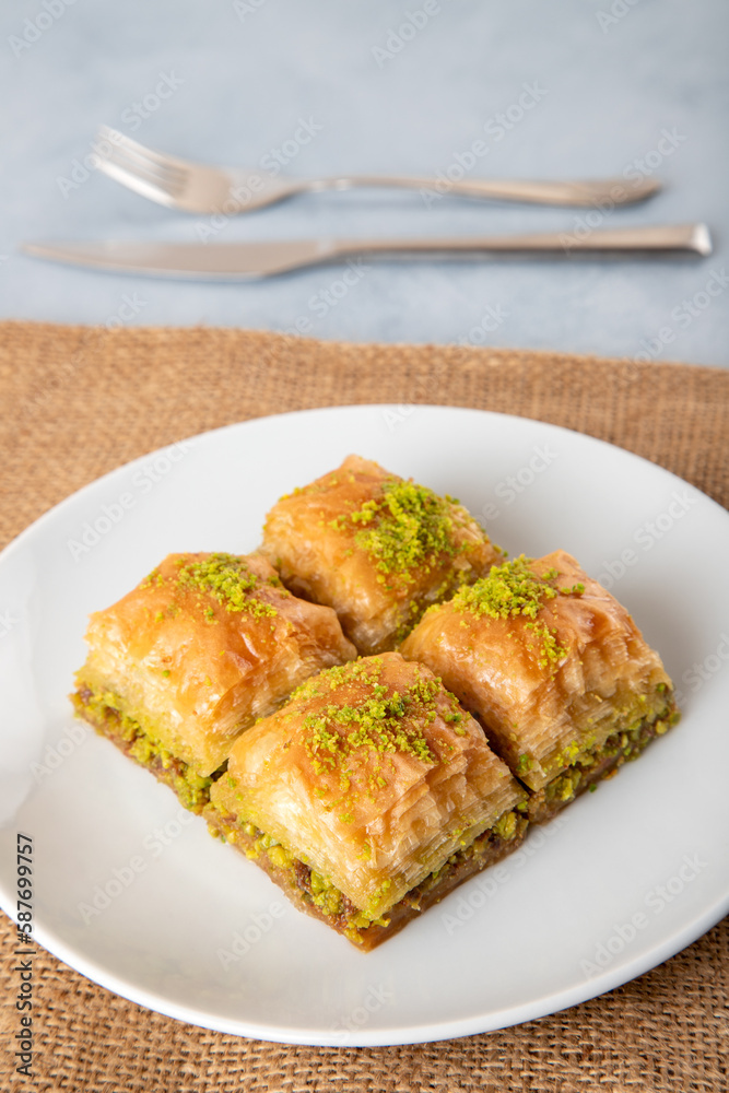 Pistachio Turkish baklava on a white plate,top view Pistachio Turkish baklava on a white plate,top view
