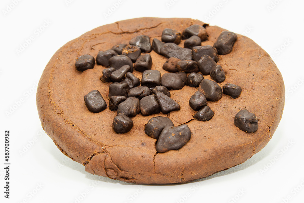 A gluten-free cocoa cookie with chocolate chips on a white background A gluten-free cocoa cookie with chocolate chips on a white background
