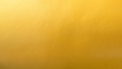 Gold wall texture background. Yellow shiny gold foil paint on wall surface with light reflection, vibrant golden luxury wallpaper