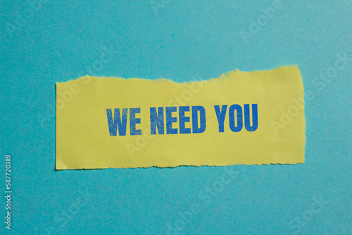 We Need You message written on ripped yellow paper