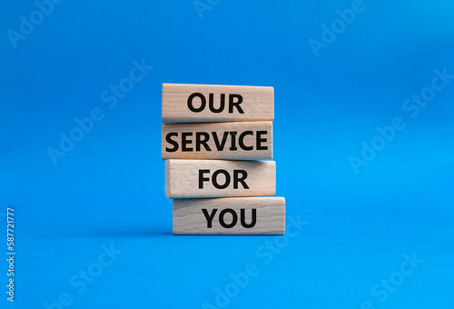 Our service for you symbol. Wooden blocks with words Our service for you. Beautiful blue background. Business and Our service for you concept. Copy space.