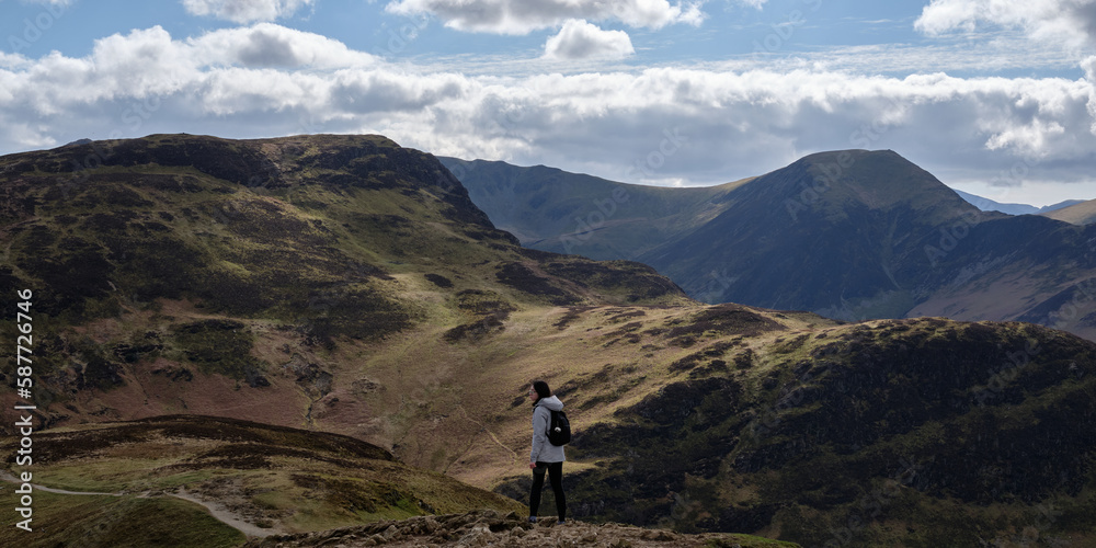 Person hiking in the mountains of Lake District, England.