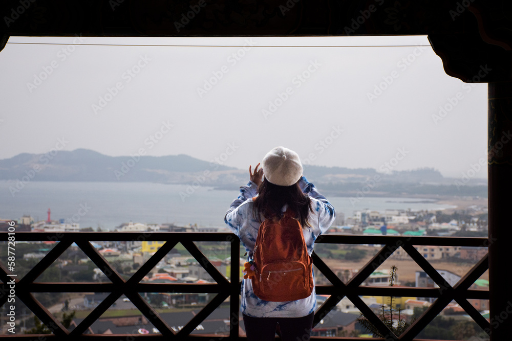 Travelers thai women people journey travel visit in Sanbangsa Temple and take photo view landscape Jeju island and cityscape Seogwipo city urban at viewpoint in Jeju do capital of South Korea