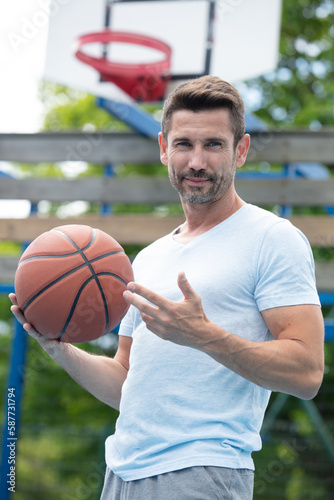 handsome male playing basketball outdoor © auremar