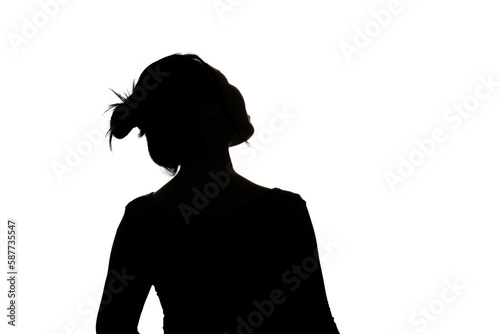 Black backlit silhouette of head and shoulders of an oriental woman from back view outlined by light