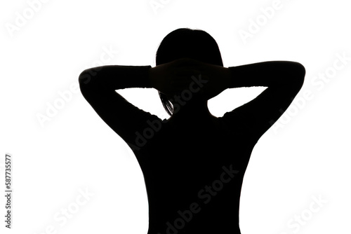 Black backlit silhouette of head and shoulders of an oriental woman from back view outlined by light