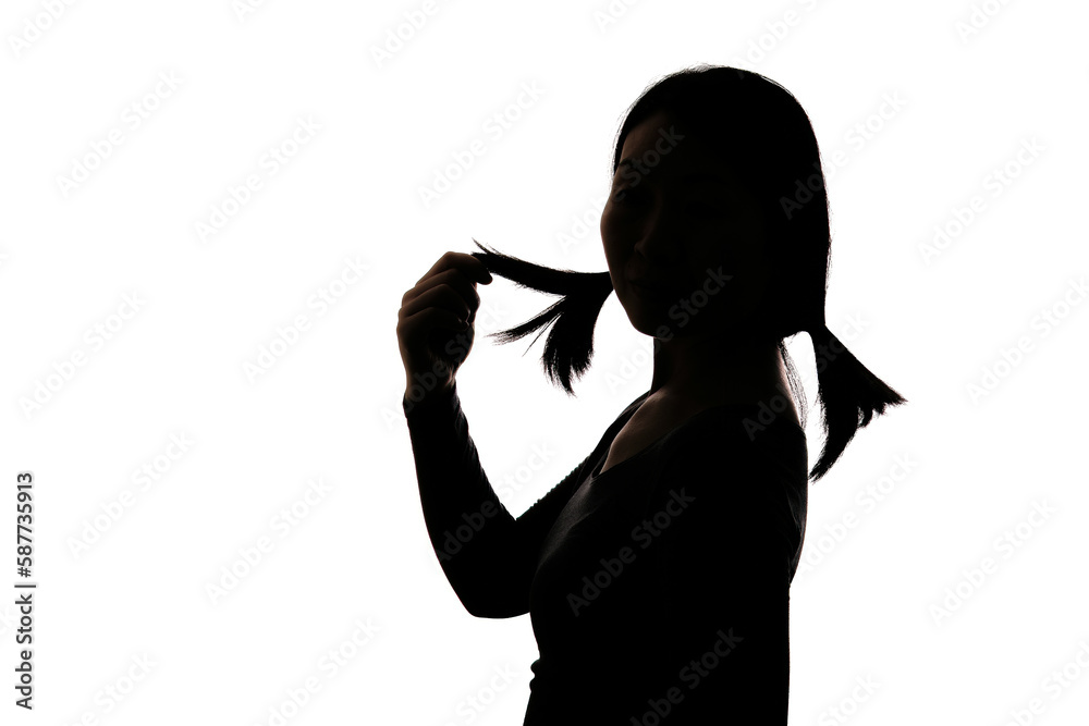 Black backlit silhouette of head and shoulders of an oriental woman from the side outlined by light