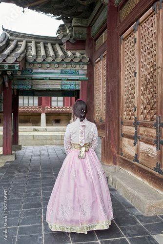 Photography Asian woman wearing a pink traditional hanbok dress in Changdeokgung Palace, Seo