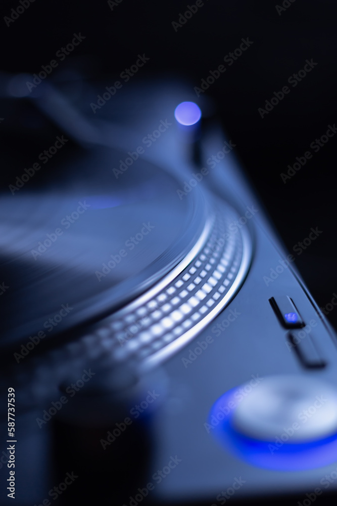 Turntable playing vinyl record with music in close up, focus on spinning platter disc Turntable playing vinyl record with music in close up, focus on spinning platter disc
