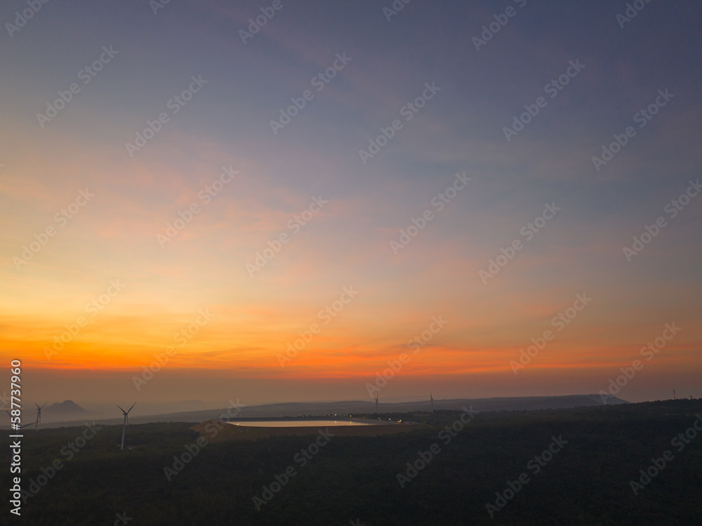 aerial view wind turbine viewpoint at Lamtakong dam,Nakhonratchasima, Thailand..amazing sky in sunrise above Lamtakong dam beautiful reflection on the large pond..Gradient color. Sky texture,