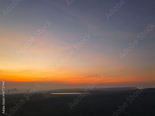 aerial view wind turbine viewpoint at Lamtakong dam,Nakhonratchasima, Thailand..amazing sky in sunrise above Lamtakong dam beautiful reflection on the large pond..Gradient color. Sky texture,