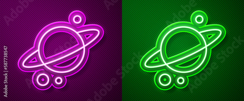 Glowing neon line Planet Saturn with planetary ring system icon isolated on purple and green background. Vector