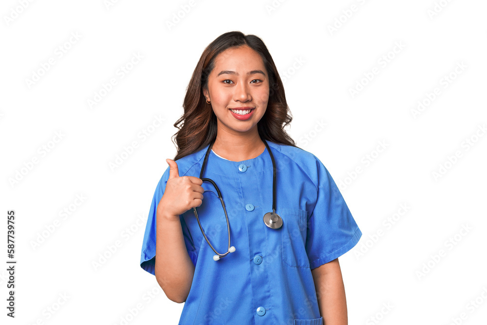 A young nurse chinese woman smiling and raising thumb up A young nurse chinese woman smiling and raising thumb up